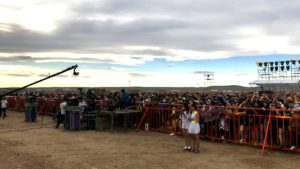 The audience gathers for the concert on the grasslands.